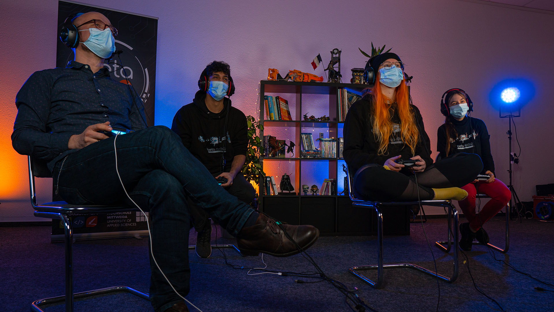 Vier Menschen mit Maske spielen das Spiel Scoo-King